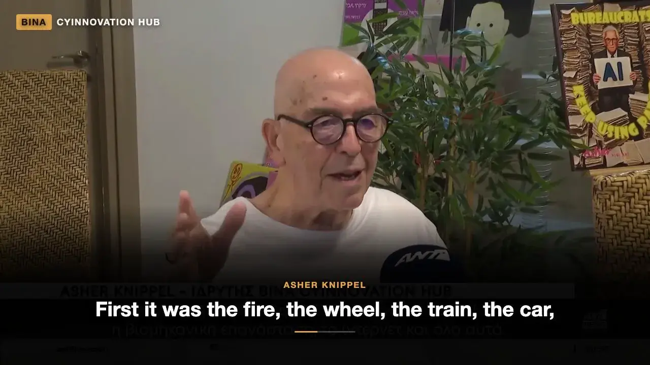 Asher Knippel, założyciel BINA CYINNOVATION HUB, mówi do mikrofonu ANT1 podczas wywiadu telewizyjnego, z angielskimi napisami.